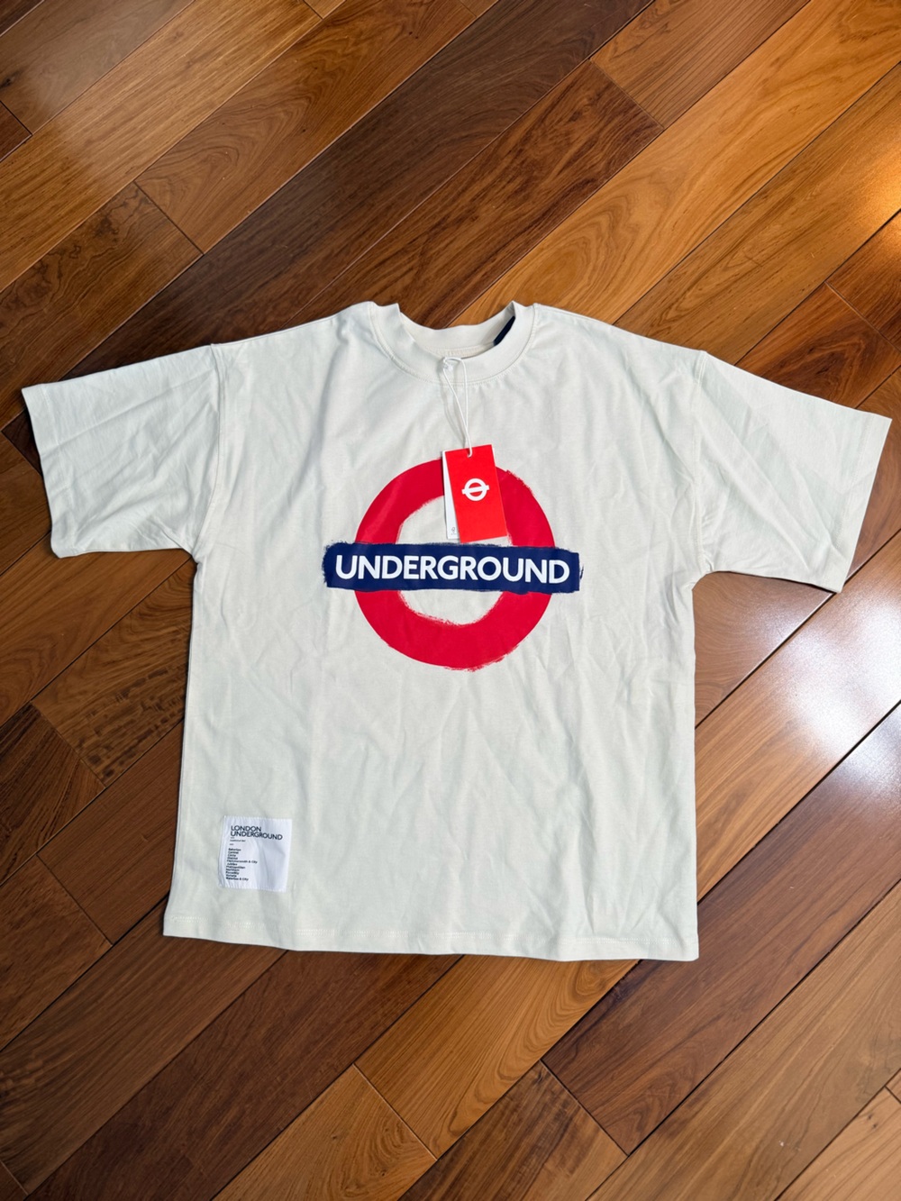 Uniqlo White Tee with Red Target and Navy UNDERGROUND Graphic